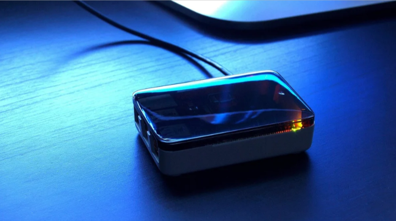 EMplayer media device glowing on a desk